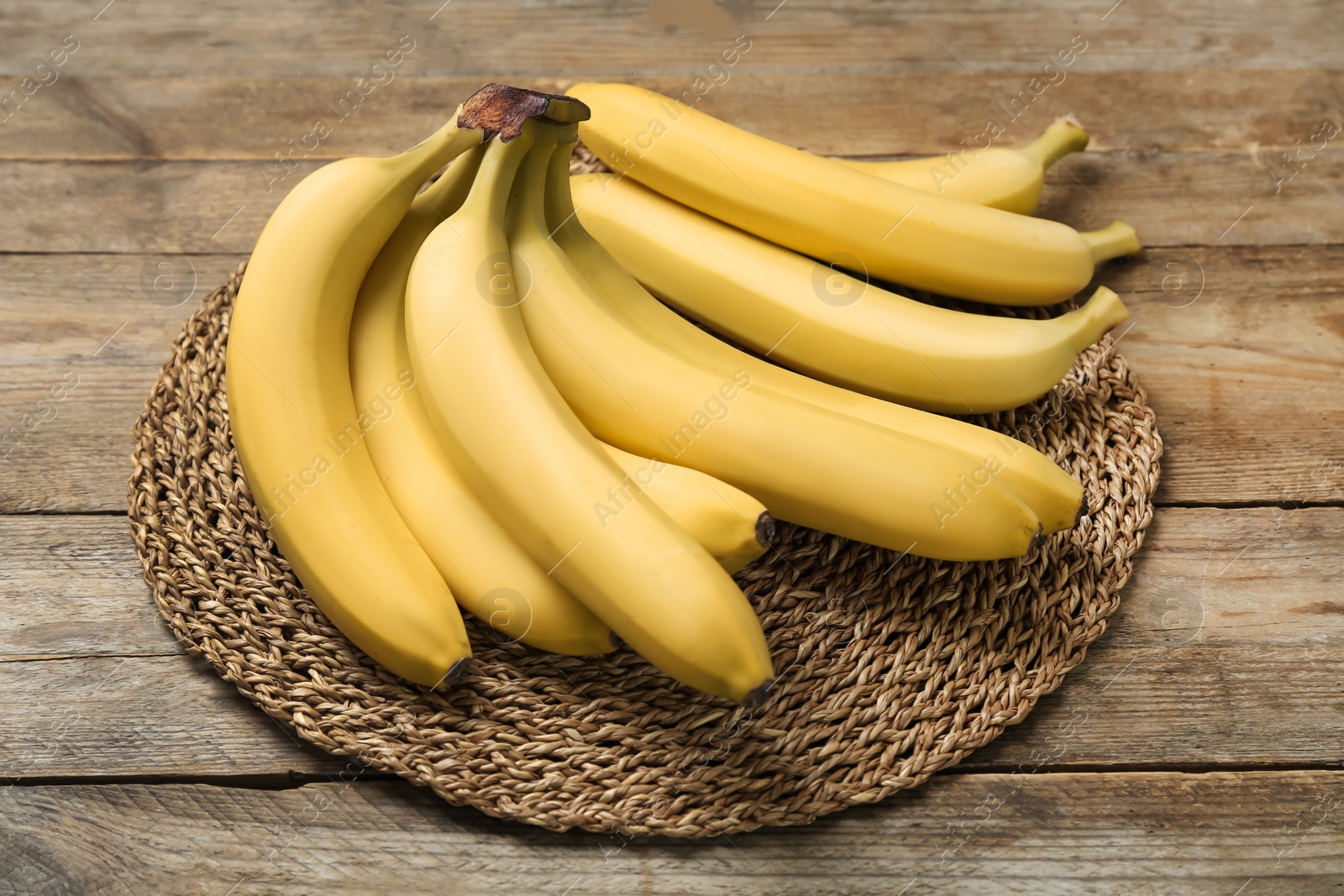 Photo of Ripe sweet yellow bananas on wooden table