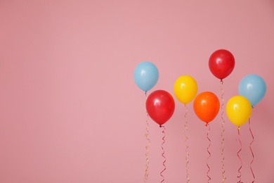 Bright balloons on color background, space for text. Celebration time