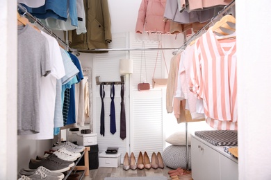 Modern dressing room with different stylish clothes and accessories