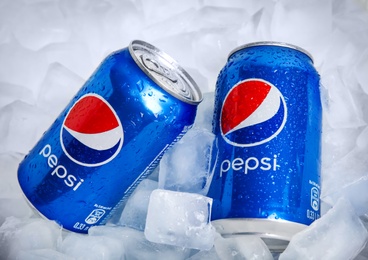 Photo of MYKOLAIV, UKRAINE - FEBRUARY 11, 2021: Cans of Pepsi on ice cubes