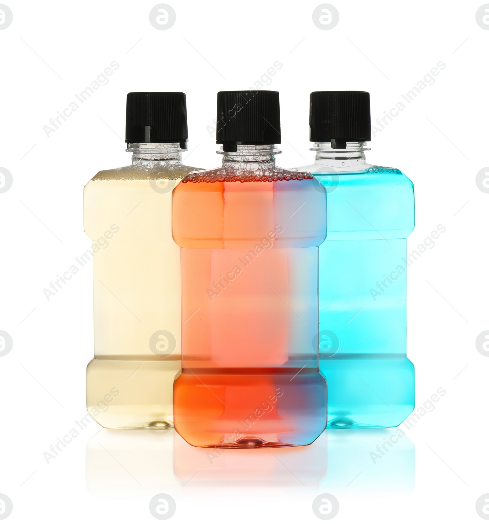 Photo of Bottles with mouthwash for teeth care on white background