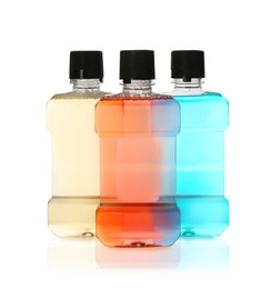 Photo of Bottles with mouthwash for teeth care on white background
