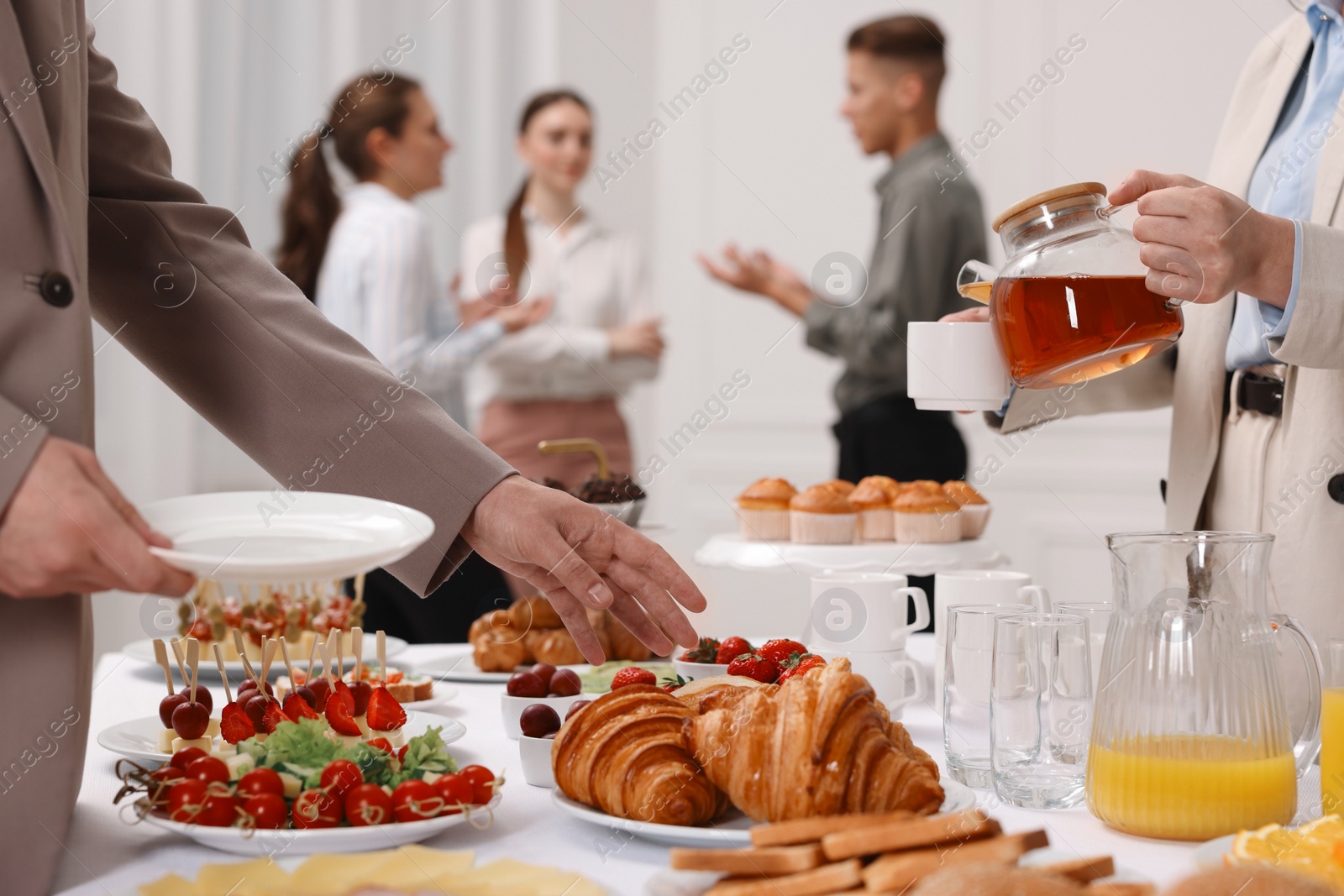 Photo of Coworkers having business lunch in restaurant, closeup