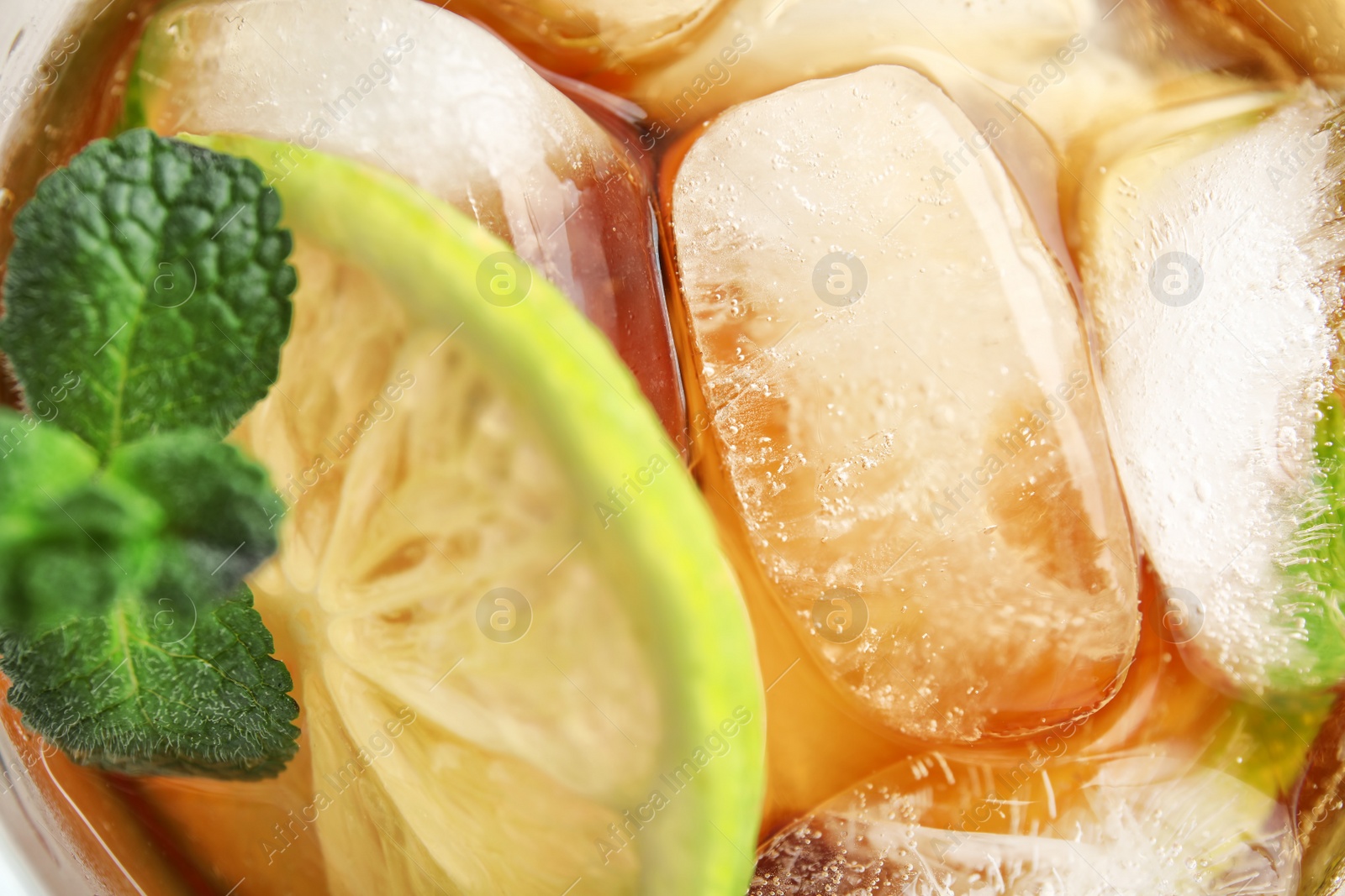 Photo of Refreshing lime drink with ice cubes in glass, top view