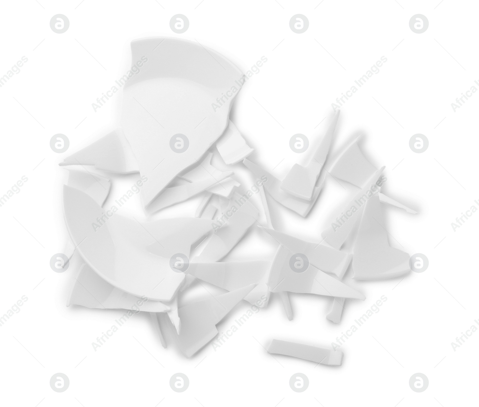 Photo of Pieces of broken ceramic plate on white background, top view