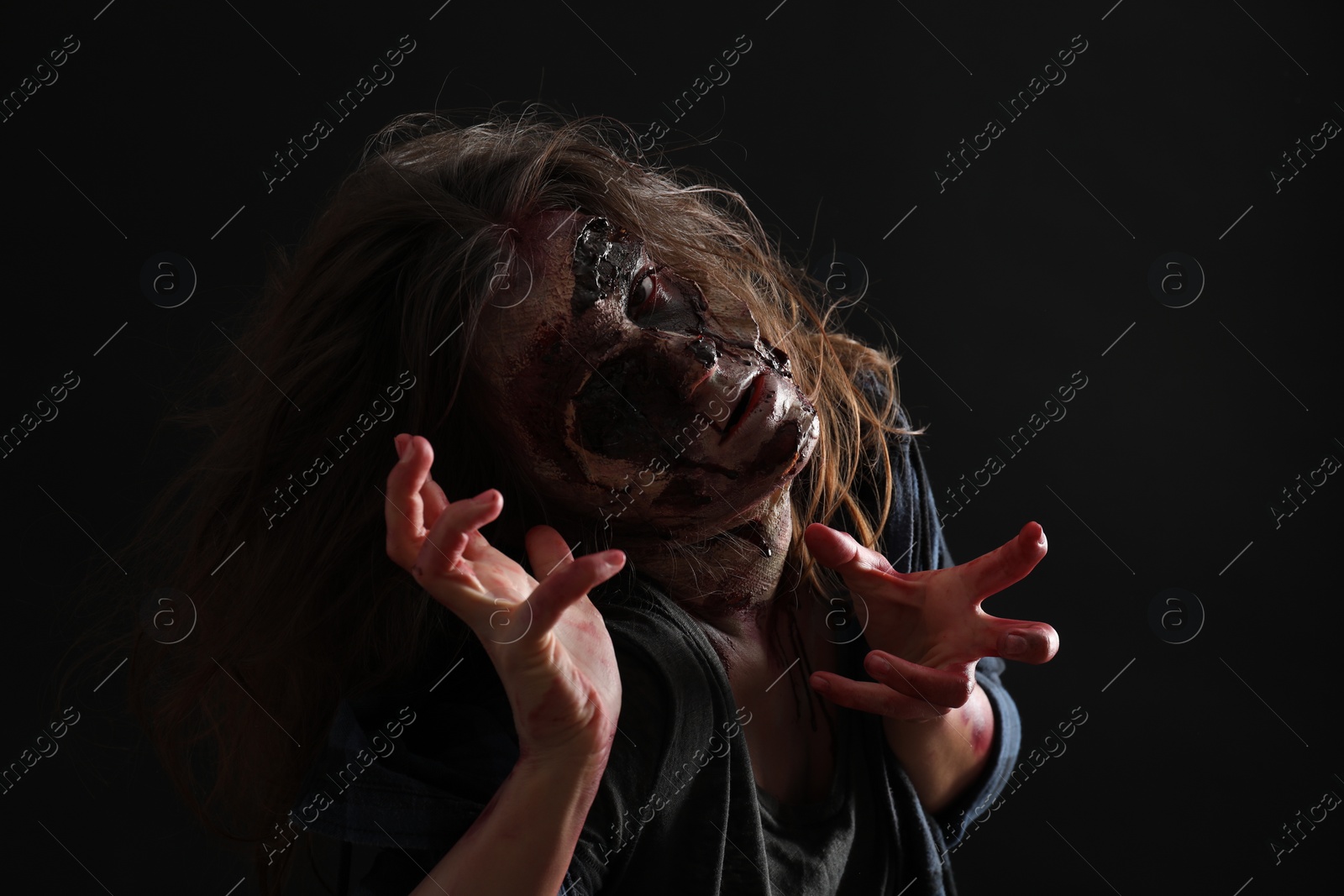 Photo of Scary zombie on dark background. Halloween monster