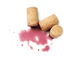 Photo of Bottle corks with wine stains on white background, top view