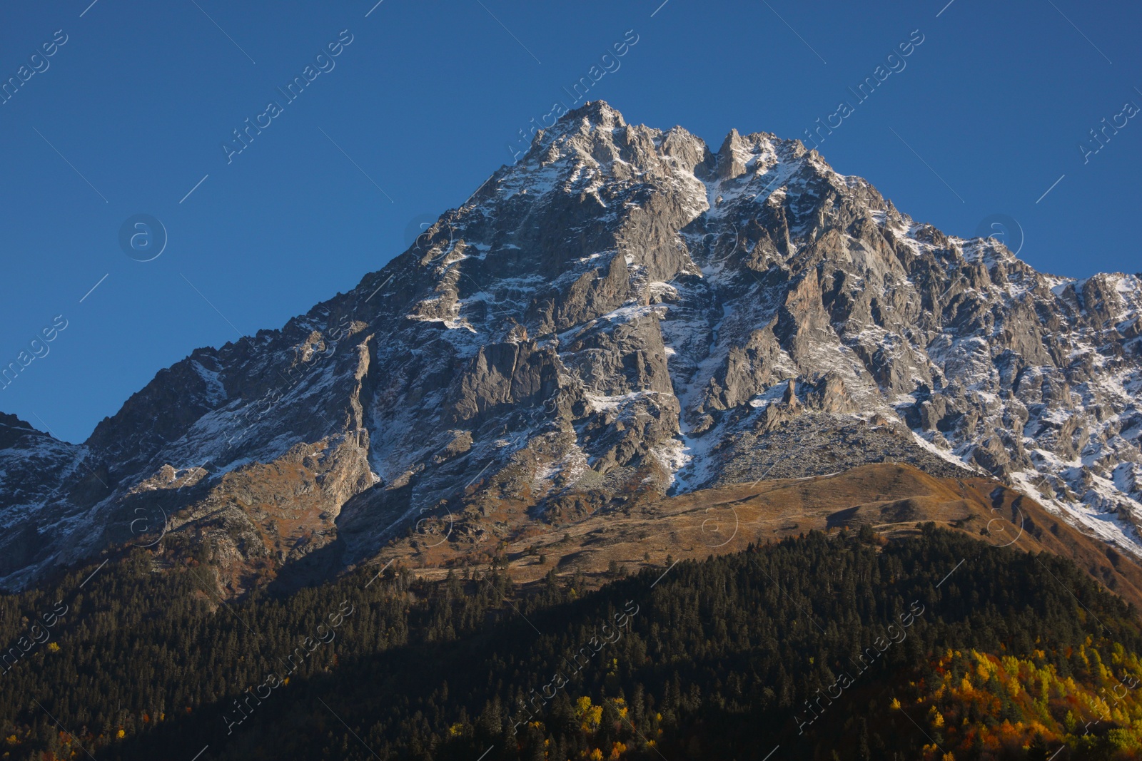 Photo of Picturesque view of beautiful high mountain under blue sky on sunny day