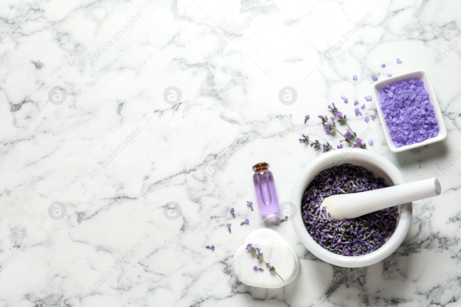 Photo of Flat lay composition with lavender flowers and natural cosmetic products on marble background. Space for text