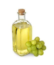 Photo of Vegetable fats. Bottle of cooking oil and fresh grapes isolated on white