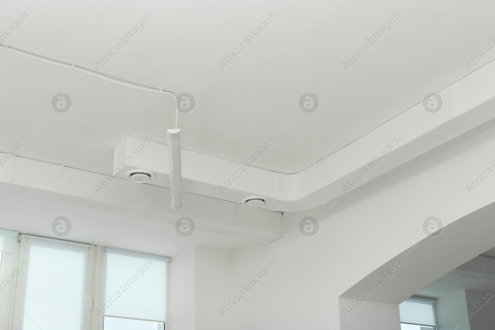 Photo of White ceiling with modern lighting in office