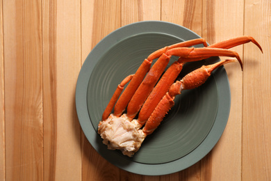 Photo of Piece of fresh raw crab on wooden table, top view