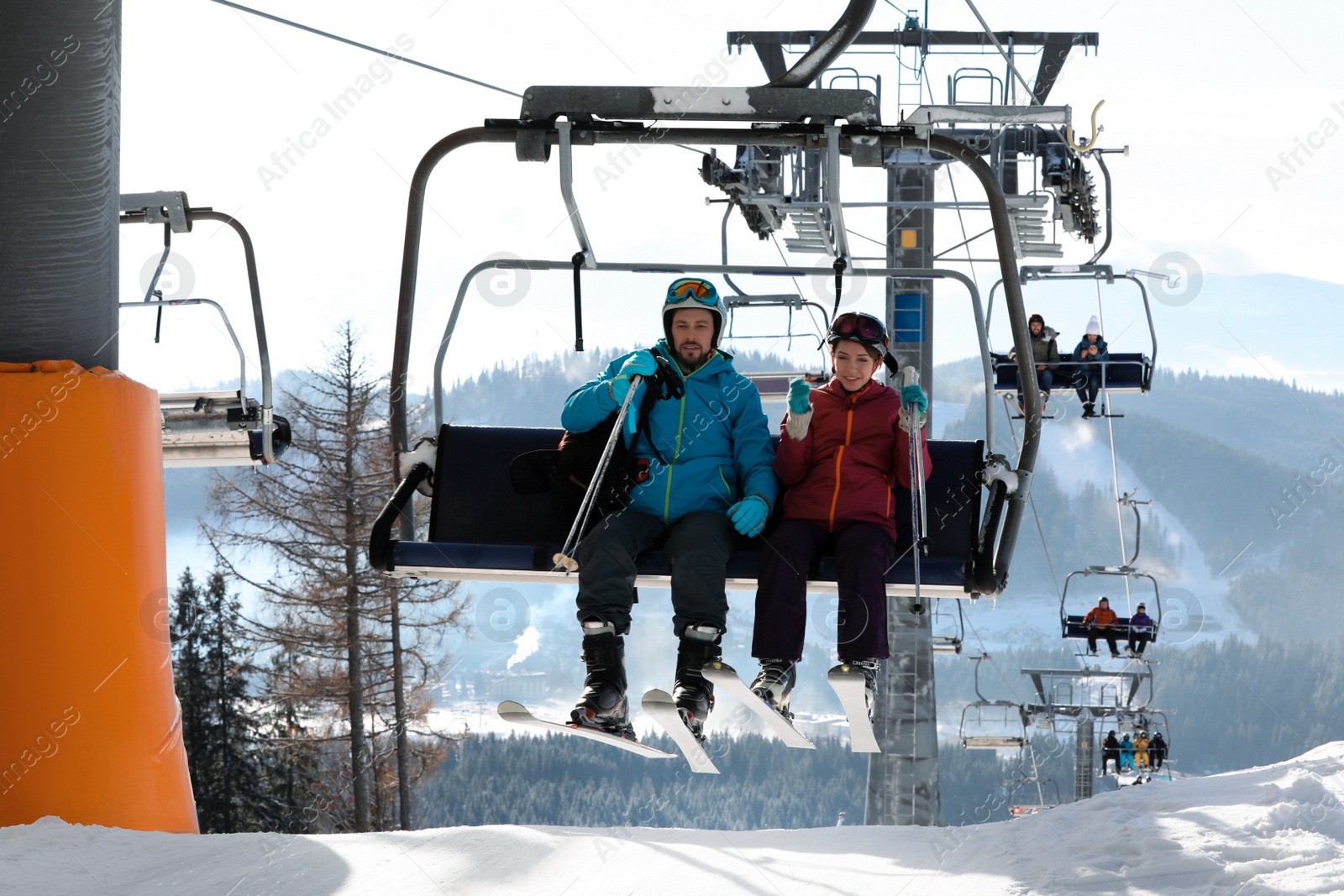 Photo of People using chairlift at mountain ski resort. Winter vacation