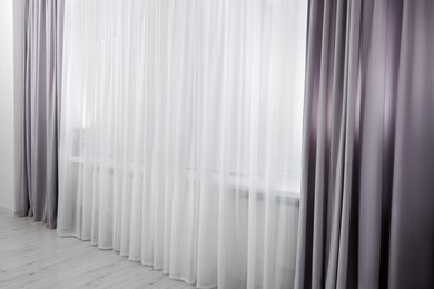 Light grey window curtains and white tulle indoors