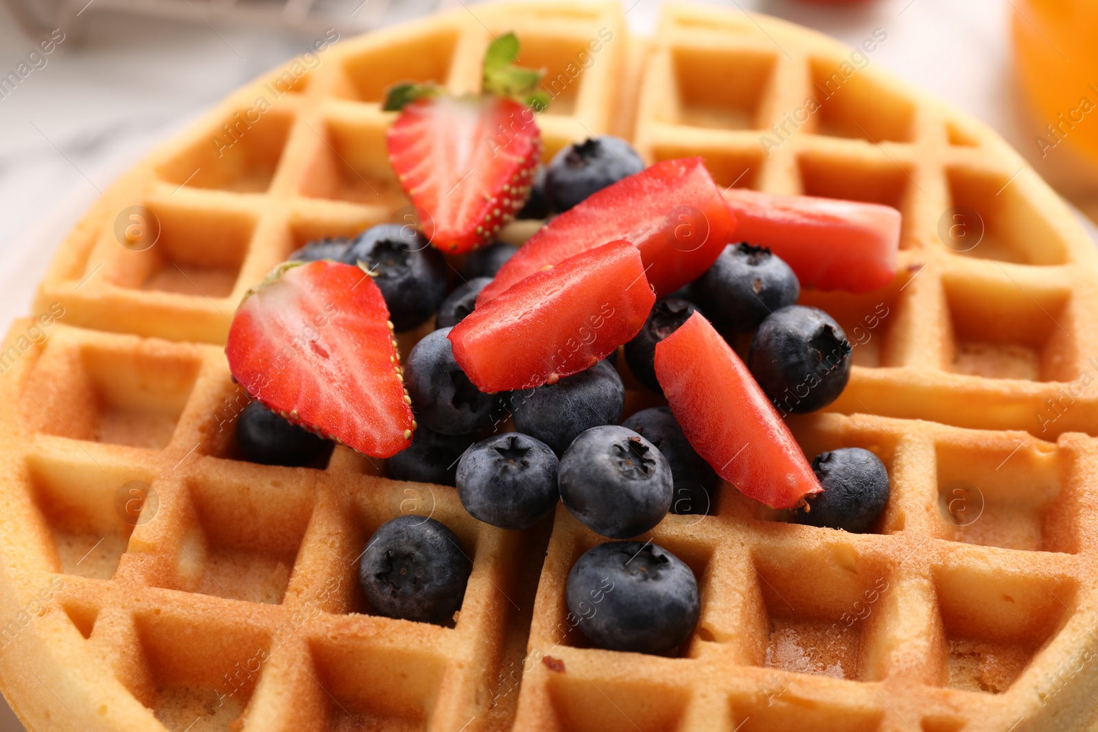 Photo of Tasty Belgian waffle with fresh berries, closeup
