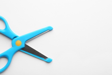 Photo of Pair of training scissors on white background