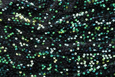 Photo of Beautiful dark sequin fabric as background, closeup