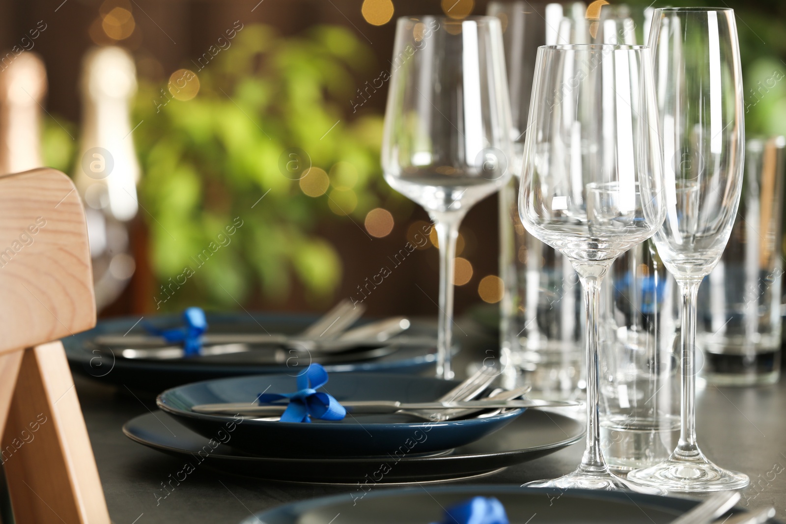 Photo of Table setting with empty glasses, plates and cutlery indoors