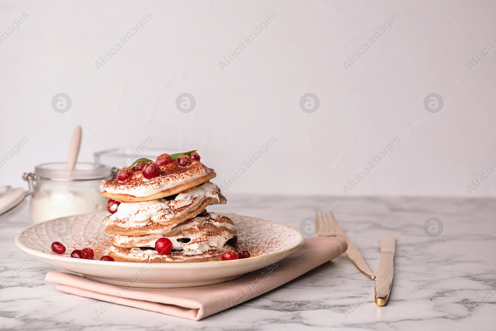 Photo of Plate with delicious pancakes on table