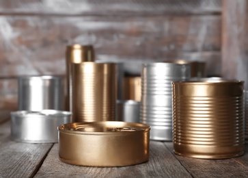 Photo of Many tin cans on table. Recycling garbage