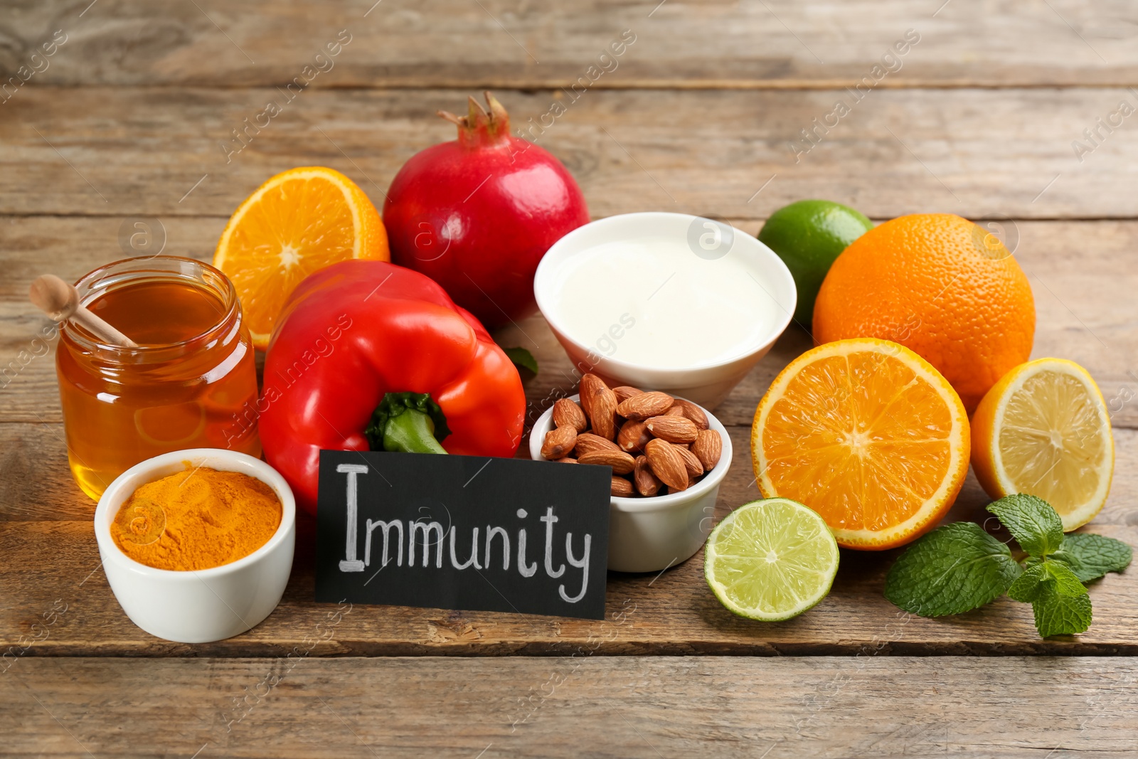 Photo of Card with word Immunity and fresh products on wooden table