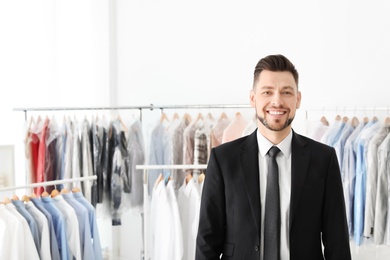 Photo of Portrait of young businessman at dry-cleaner's