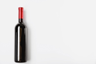 Photo of Bottle of delicious wine on white background