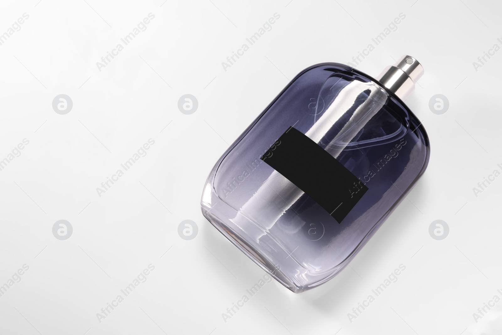 Photo of Luxury men`s perfume in bottle on white background, top view. Space for text