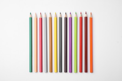 Photo of Colorful wooden pencils on white background, flat lay