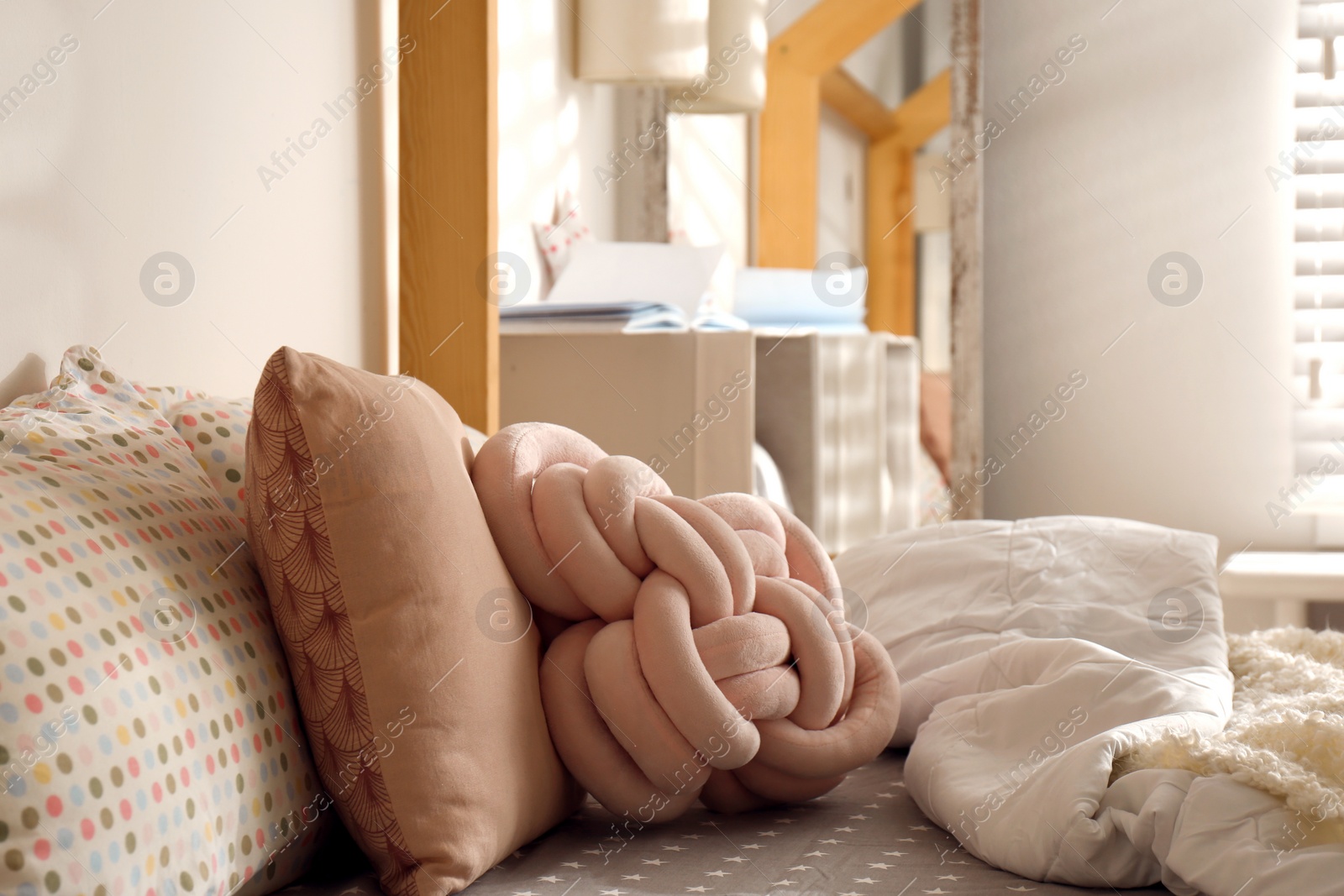 Photo of Soft pillows on bed in cozy room interior