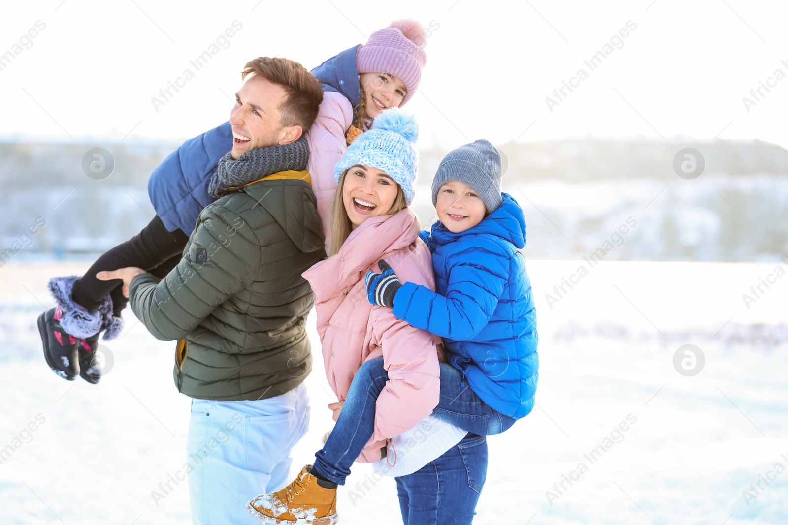 Photo of Happy family having fun outdoors on winter day