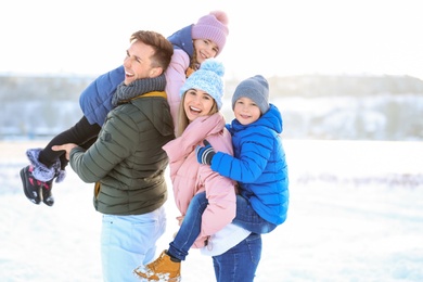 Photo of Happy family having fun outdoors on winter day