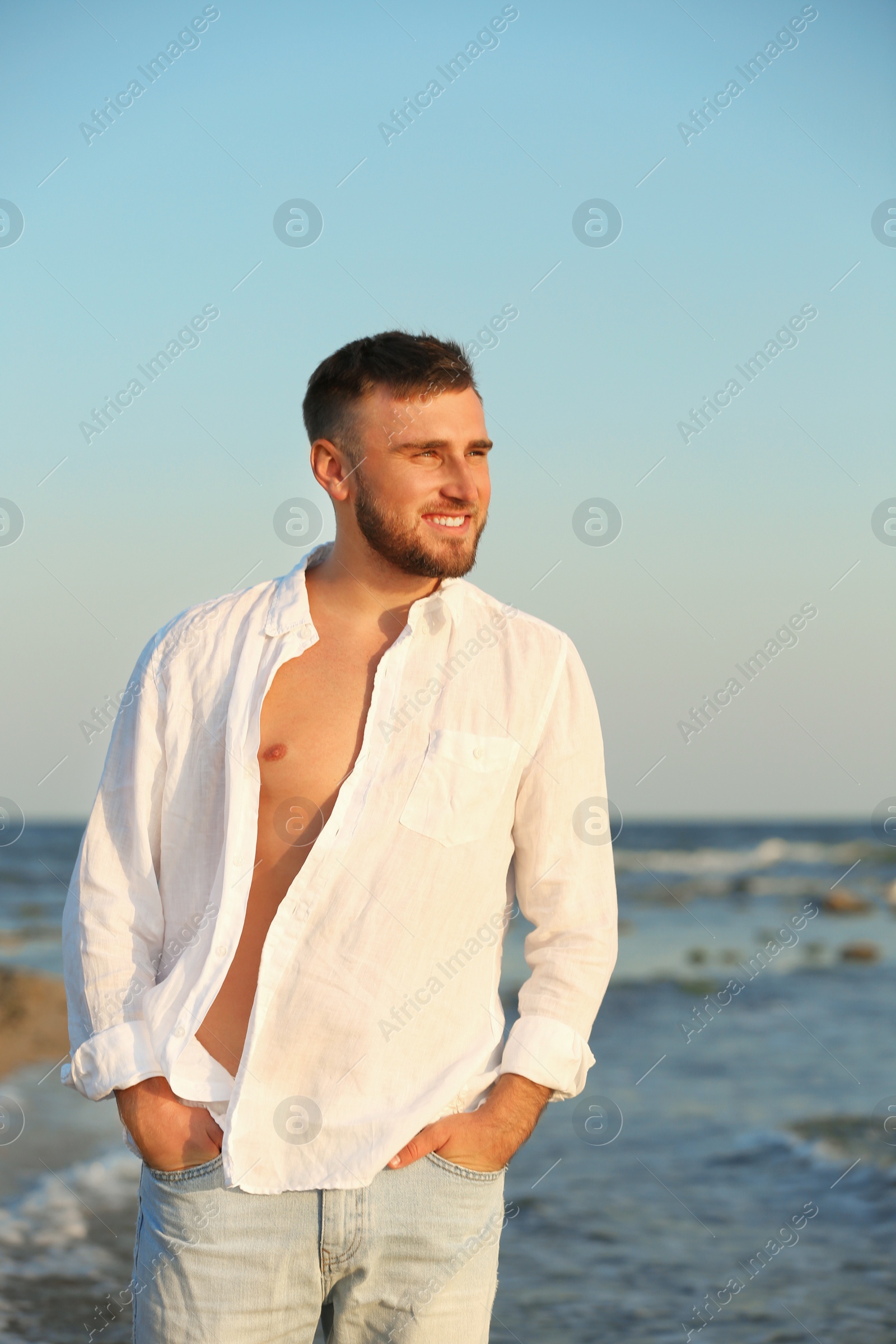 Photo of Young man enjoying sunny day on beach