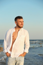 Young man enjoying sunny day on beach