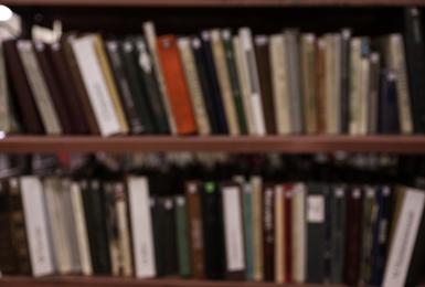 Blurred view of shelves with books in library