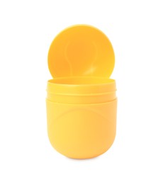 Slynchev Bryag, Bulgaria - May 23, 2023: Opened yellow plastic capsule from Kinder Surprise Egg isolated on white