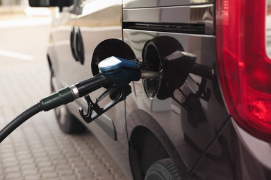 Refueling modern car at gas filling station, closeup