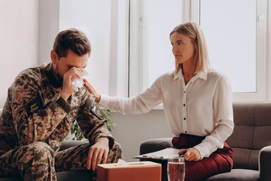 Photo of Psychologist working with military officer in office