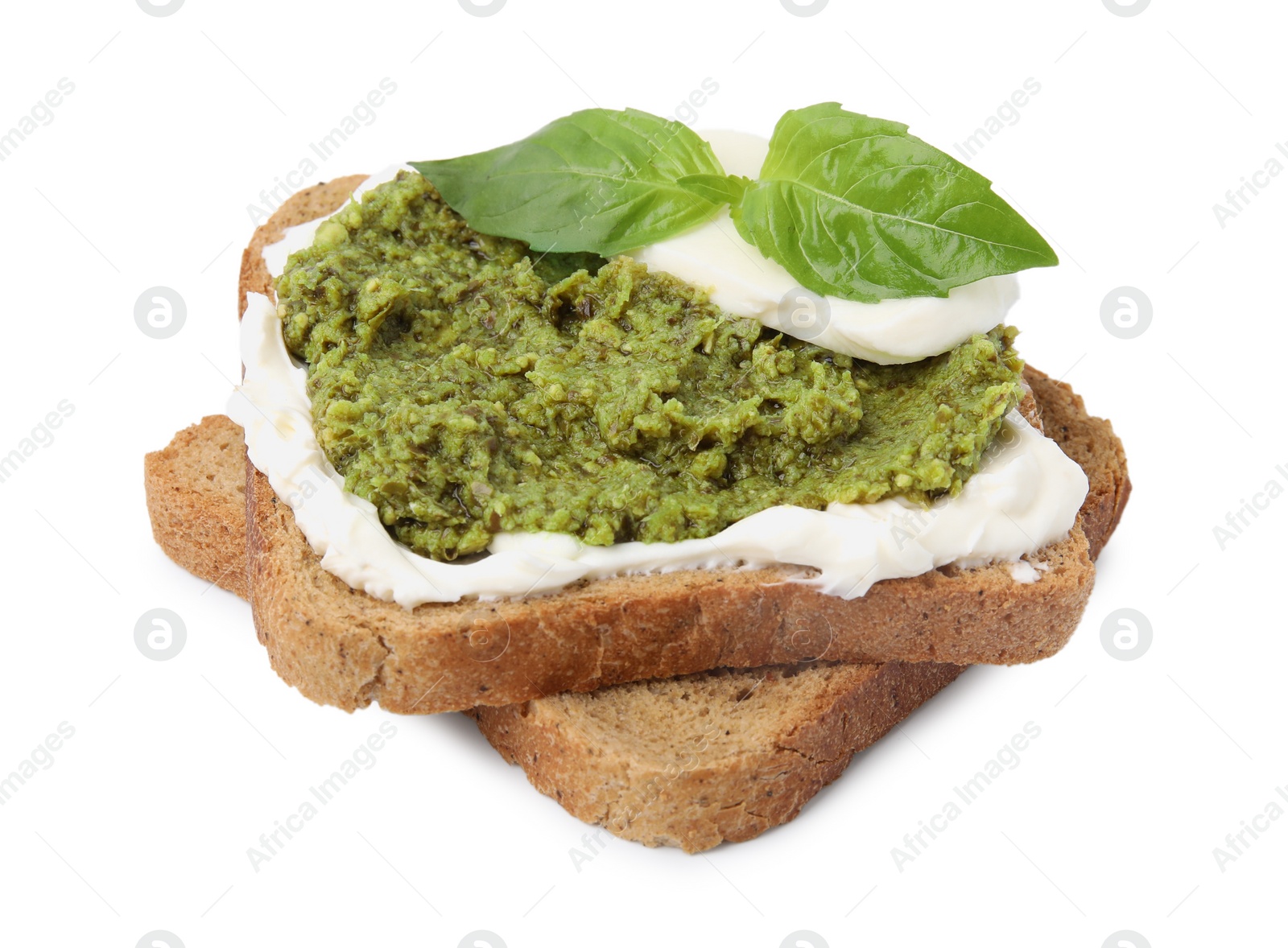 Photo of Tasty bruschetta with cream cheese, pesto sauce and fresh basil on white background