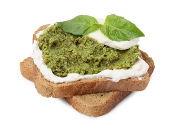 Photo of Tasty bruschetta with cream cheese, pesto sauce and fresh basil on white background