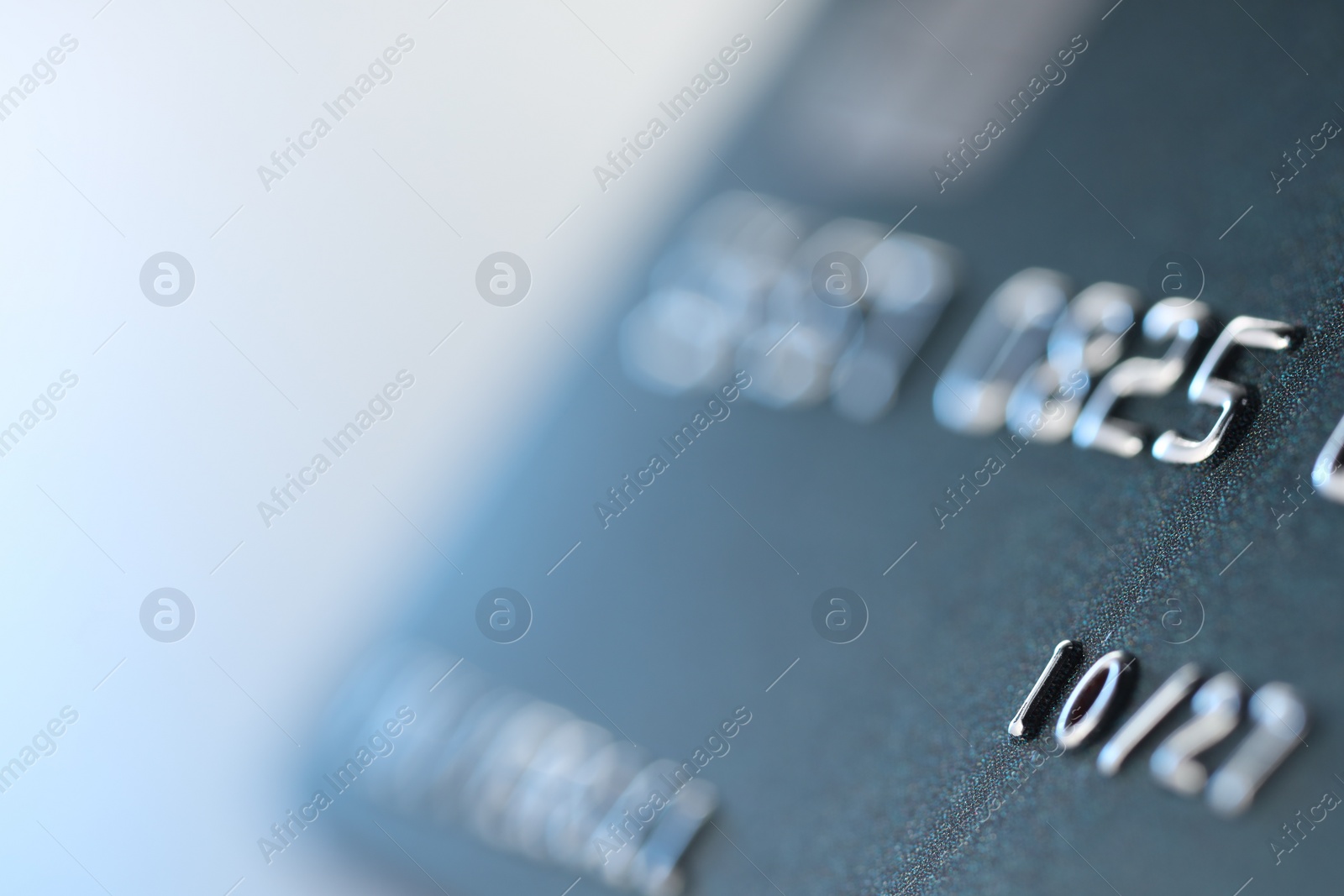 Photo of One credit card on light background, macro view