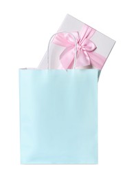 Light blue paper shopping bag with gift box on white background