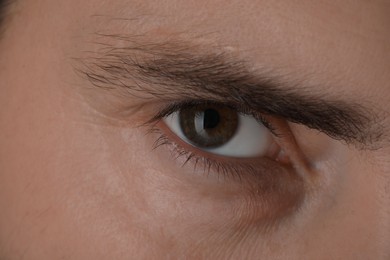 Photo of Evil eye. Man with scary eyes, closeup view