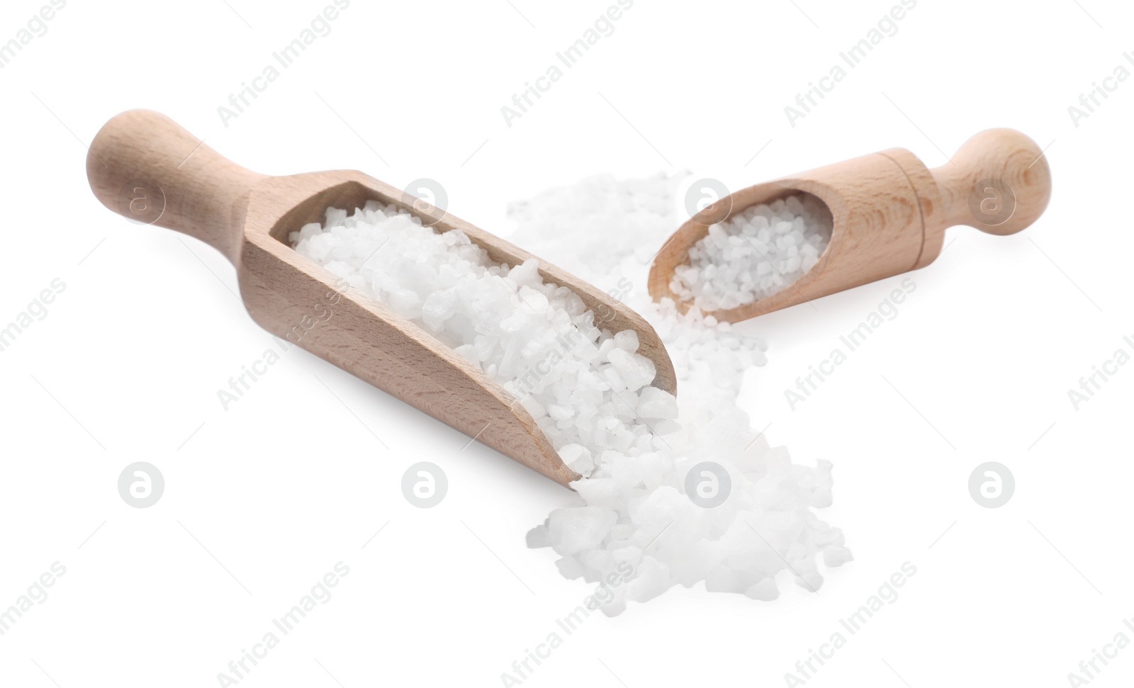 Photo of Natural salt and wooden scoops isolated on white