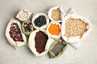 Different grains and seeds on white table, flat lay. Veggie diet