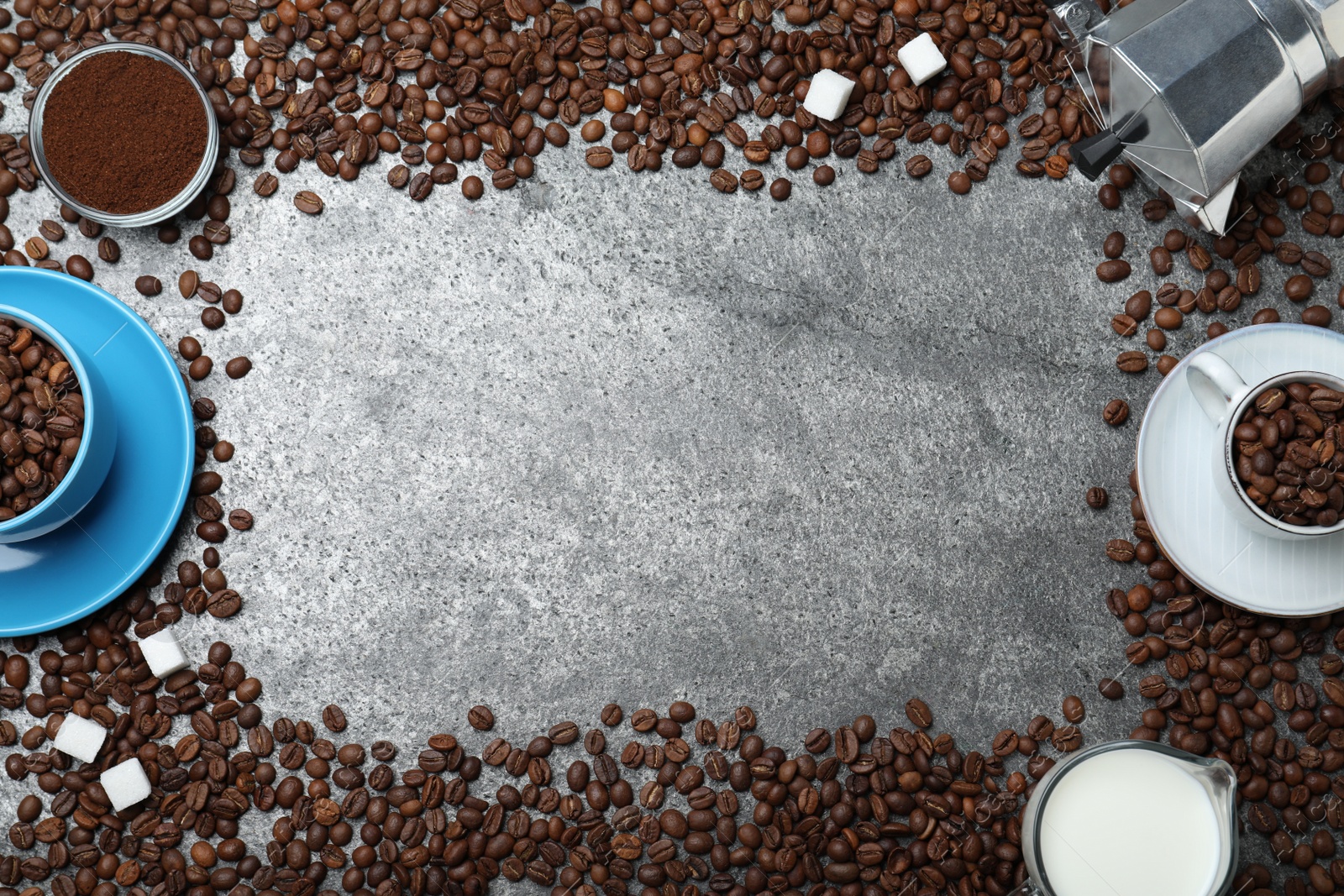 Photo of Flat lay composition with roasted coffee beans on grey table. Space for text