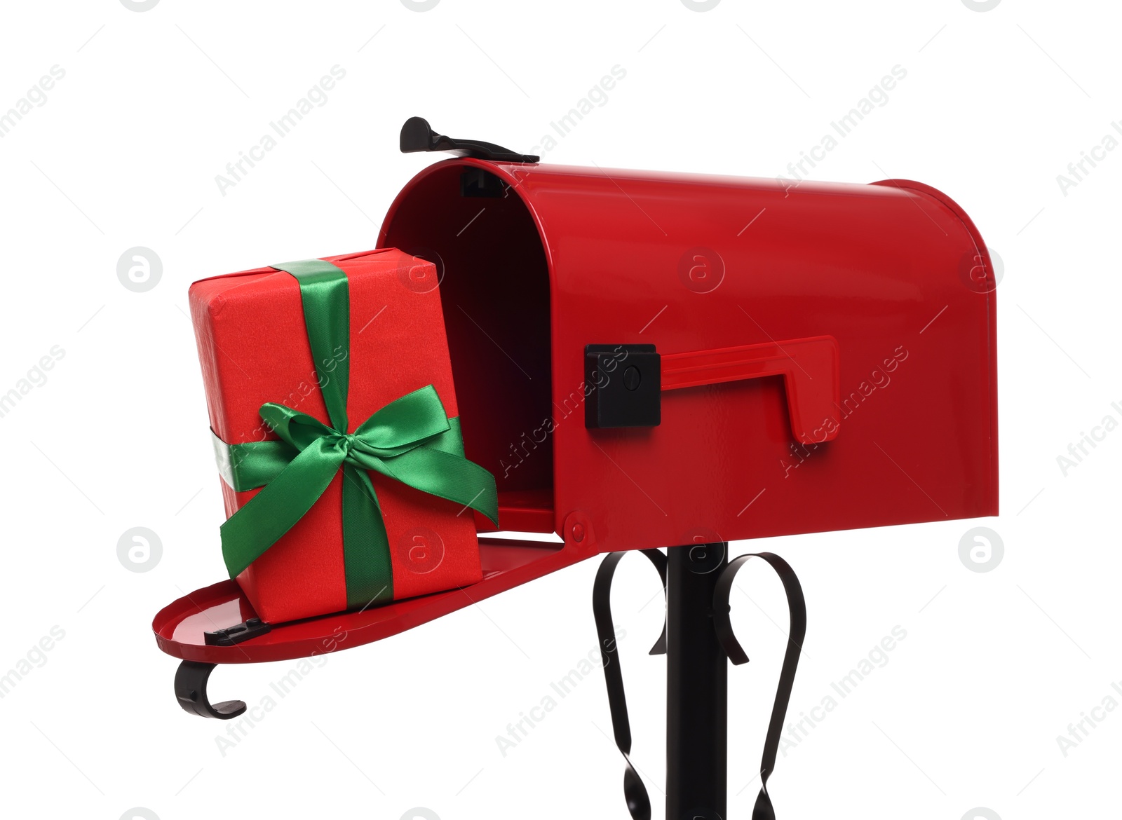 Photo of Red mailbox with Christmas gift isolated on white. Sending present by mail