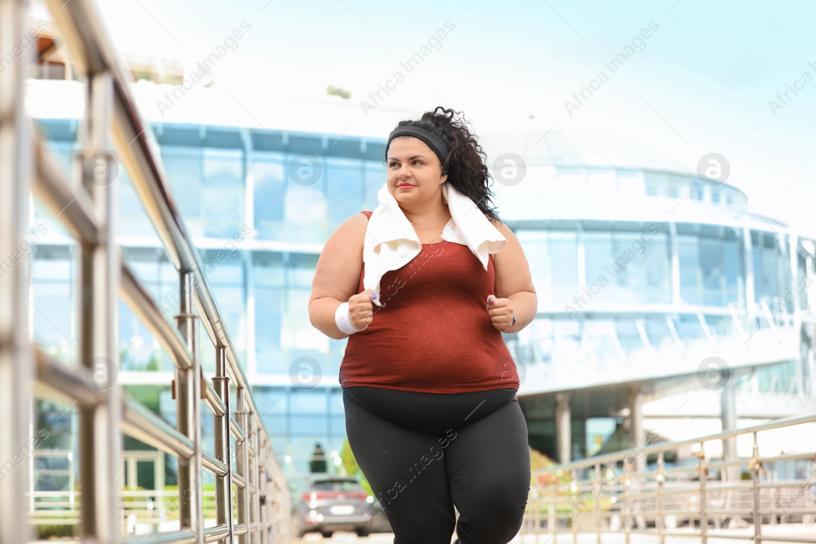 Photo of Beautiful overweight woman running outdoors. Fitness lifestyle