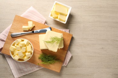 Tasty butter with dill and knife on wooden table, flat lay. Space for text