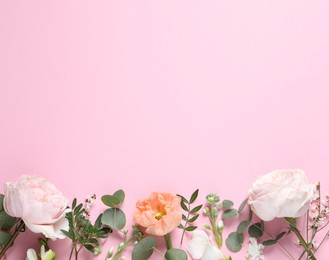 Photo of Flat lay composition with different beautiful flowers on pink background. Space for text